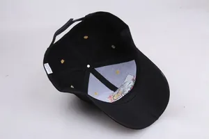 Detail of 100% cotton baseball cap interior showing the eagle embroidery and wash label