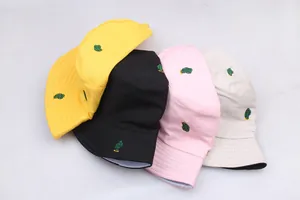 Reversible cactus embroidery bucket hats in yellow, black, pink, and beige cotton fabric