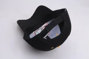 Detailed view of black cotton baseball cap interior with embroidery and velcro strap
