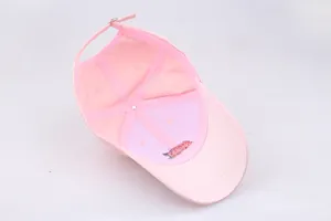 Internal view of pink baseball cap showing rose embroidery and adjustable metal buckle