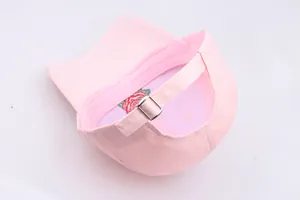 Detailed view of pink baseball cap back with metal buckle and rose embroidery