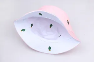 Detail of pink bucket hat with white lining featuring green cactus embroidery