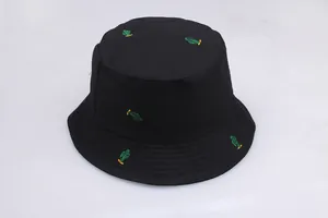 Close-up of green cactus embroidery on black cotton fabric of a bucket sun hat