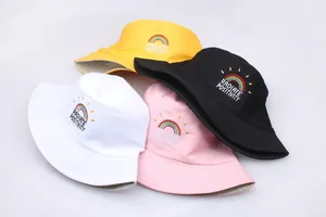 Detailed embroidery of rainbow pattern and text on cotton bucket hats in four colors