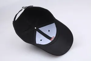 Inside view of black baseball cap with rose embroidery and adjustable metal buckle