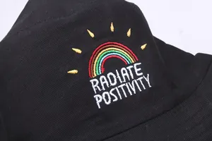 Black cotton bucket hat featuring rainbow and Radiate Positivity embroidery details