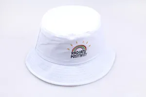 Detailed view of rainbow embroidery and Radiate Positivity text on a white bucket hat