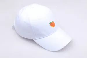 Gros plan de la broderie pêche sur une casquette de baseball en coton blanc pur