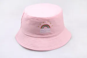 Detail of pink cotton bucket hat with rainbow embroidery and Radiate Positivity text