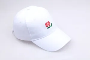 Close-up of red rose embroidery on a premium white cotton six-panel baseball cap