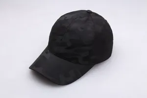 Detail shot of the dark camouflage pattern and durable knit texture on the baseball cap