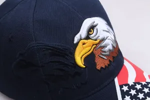 Close-up of eagle embroidery and US flag detail on dark blue baseball cap cotton fabric