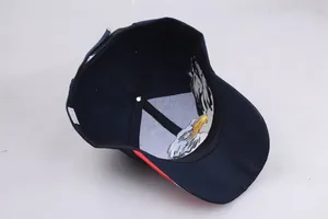 Detailed interior of navy baseball cap featuring bald eagle print and red brim piping