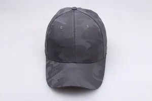 Detailed macro view of dark grey camouflage fabric on the casual outdoor baseball cap