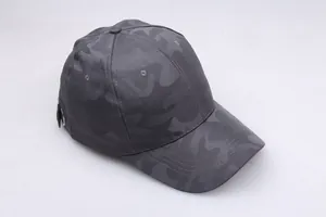 Detail of grey camouflage baseball cap showing breathable mesh fabric and metal buckle