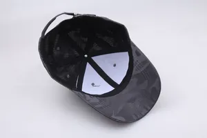 Detail of the camouflage baseball cap interior with mesh texture and adjustable metal buckle