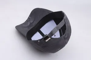 Detail of camouflaged baseball cap with adjustable metal buckle and inner sweatband
