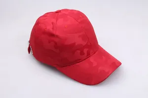 Detail of red camouflage baseball cap with adjustable silver buckle and mesh texture