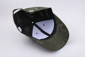 Detail view of camouflage baseball cap showing inner seams and adjustable metal buckle