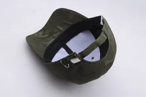 Detail view of camouflage baseball cap with metal buckle and internal wash label
