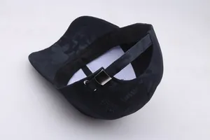 Macro view of blue camo baseball cap with adjustable metal buckle and stitching details