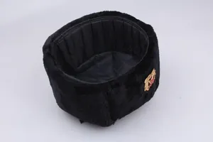 Close-up of black faux fur trapper hat with inner quilted lining and red star badge
