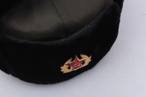 Detail of winter ushanka hat with faux fur and vintage military soviet star badge