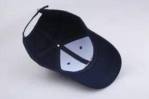 Detail of navy cotton baseball cap interior showing metal buckle and white lining