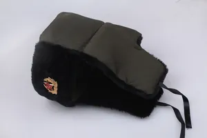 Detail of Soviet style trapper hat with golden red star badge and faux fur lining