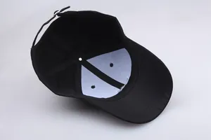 Detailed inner view of black canvas baseball cap with reinforced stitching and metal buckle