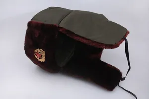 Close-up of thick dark green Ushanka hat with faux fur lining and red star emblem