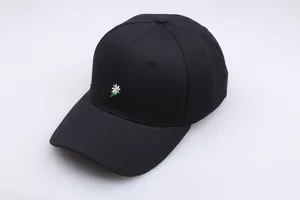 Détail d'une broderie de marguerite blanche sur le devant d'une casquette de baseball noire