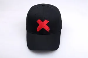 Streetwear black hip-hop baseball cap featuring bold red X embroidery on the front panel