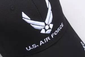 Close-up of thick white U.S. AIR FORCE embroidery on a black cotton twill baseball cap
