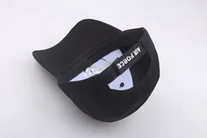 Detail of adjustable Velcro strap with white Air Force text on a black baseball cap