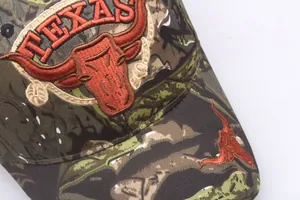 Outdoor camouflage baseball cap with Texas Longhorn 3D embroidery on a white background