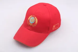 Close-up of golden Soviet Union emblem embroidery on a red cotton baseball cap