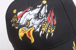 Macro shot of high-density eagle embroidery on black cotton twill baseball cap fabric