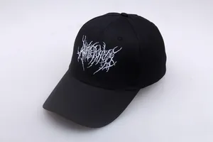 Close-up of white gothic embroidery on a black punk style baseball cap with curved brim