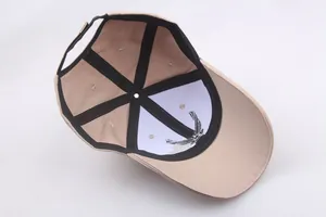Detail showing inner structure of cotton baseball cap with reinforced seams and embroidery