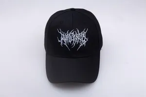 Close-up of white death metal style embroidery on a black cotton gothic baseball cap