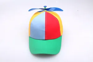 Top view of colorful propeller hat with blue plastic spinning blades and vibrant panel design