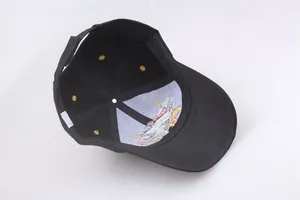 Detailed view of the internal stitching and eagle embroidery on a black cotton baseball cap