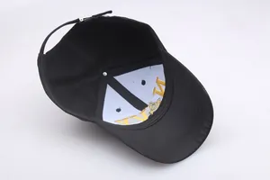 Detail view showing the interior structure and NY embroidery of the black cotton baseball cap
