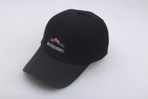 Close-up of black cotton baseball cap featuring high-quality colorful mountain embroidery