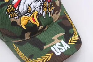Detailed close-up of USA embroidery and golden laurel leaves on camo baseball cap