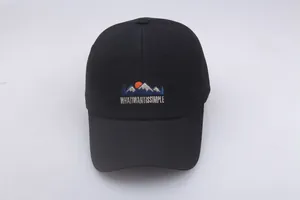 Close-up of a black cotton baseball cap with mountain sun embroidery and text detail