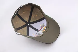 Detailed interior of camo baseball cap showing eagle embroidery and 6-panel stitching