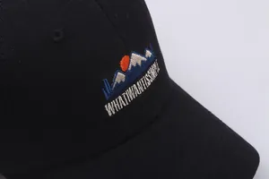 Black cotton baseball cap featuring embroidered snow mountain landscape and simple text