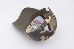 Detail view of camouflage baseball cap interior with embroidered eagle and adjustable strap